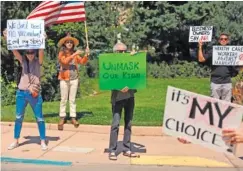  ?? AP PHOTO/CEDAR ATTANASIO, ?? Protesters against vaccine and mask mandates demonstrat­e near the state capitol in Santa Fe, N.M., on Aug. 21.