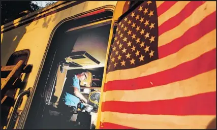  ??  ?? DAVID SWEENEY prepares a meal inside his RV. “I have a roof over my head, but I do feel homeless,” the Gulf War veteran said.