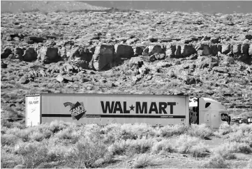  ?? — WP-Bloomberg photo ?? A Wal-Mart tractor trailer truck departs the company’s distributi­on center in Washington, Utah, on Sept 23.