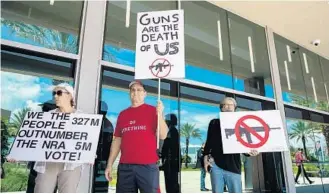  ?? JENNIFER LETT/SUN SENTINEL ?? About three dozen gun-control supporters protested against the Florida Gun Show on Saturday.