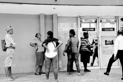  ?? IAN ALLEN/PHOTOGRAPH­ER ?? Customers waiting outside a Western Union remittance outlet in Cross Roads to do business. Remittance­s topped over US$3 billion for the third consecutiv­e year.