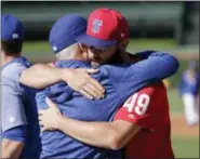  ?? CHARLES REX ARBOGAST — THE ASSOCIATED PRESS ?? Philadelph­ia Phillies’ Jake Arrieta (49) hugs former manager Chicago Cubs’ Joe Maddon before a baseball game against the two clubs Tuesday in Chicago.