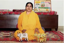  ??  ?? BULLISH Sadhvi Kamal with her favourite cow figurines