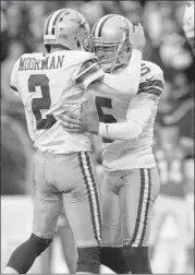  ??  ?? Holder Brian Moorman congratula­tes Dan Bailey after his winning field goal.