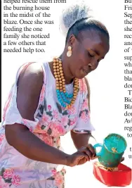  ?? ?? Liezel Mathomane dishes up soup for a member of the community.