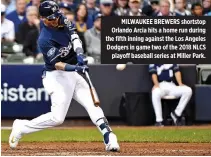  ??  ?? MILWAUKEE BREWERS shortstop Orlando Arcia hits a home run during the fifth inning against the Los Angeles Dodgers in game two of the 2018 NLCS playoff baseball series at Miller Park.