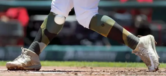  ?? JEFF ROBERSON/THE ASSOCIATED PRESS ?? Major League Baseball’s custom sock looks include the camouflage pattern the St. Louis Cardinals’ Matt Carpenter, above, sported on Memorial Day. Meantime, New York Mets players find their skyline socks are a little busy.