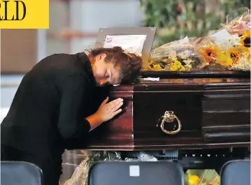  ?? ANTONIO CALANNI / THE ASSOCIATED PRESS ?? A woman mourns a victim of the collapsed Morandi Bridge at the Fiera di Genova exhibition centre in Genoa, where some of the coffins were laid in state on Friday. The accident has put a spotlight on Italy’s troubled infrastruc­ture.