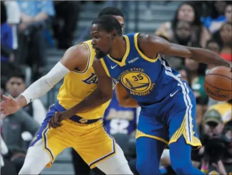  ?? JOHN LOCHER — THE ASSOCIATED PRESS ?? Golden State Warriors forward Kevin Durant drives against Los Angeles Lakers guard Josh Hart during the first half of a preseason game in Las Vegas.