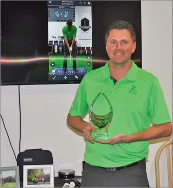  ??  ?? Jeff Chambers with the PGA of Canada Ben Kern Coach of the Year award inside his coaching academy at the Elmwood Golf &amp; Country Club, Jan. 27.