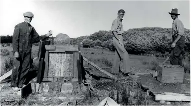  ??  ?? Guy Powles, left, constructs Bess’ grave, with his two sons.