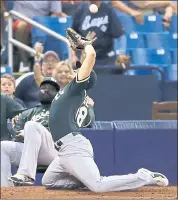 ?? CHRIS O’MEARA — THE ASSOCIATED PRESS ?? A’s left fielder Chad Pinder trips over the bullpen mound trying to catch a foul ball hit by the Rays’ Jake Bauers.