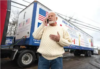  ?? ?? Businessma­n Bob Bolus talks on his phone outside his business in Throop, Pennsylvan­ia, before driving his truck on a “Freedom Convoy” from Scranton to Washington, D.C., on Feb. 23.