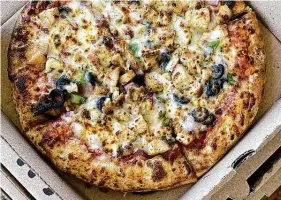  ??  ?? Specialty pizza options include Santa Fe Chicken with grilled chicken, onion, black olives and green peppers.