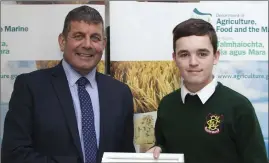  ??  ?? Pierce Ryan from FCJ Bunclody receives his certificat­e from Minister of State for the Department of Agricultur­e, Food and the Marine, Andrew Doyle.