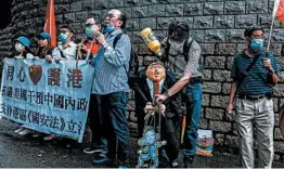  ?? ISAAC LAWRENCE/GETTY-AFP ?? An activist holds an effigy of President Donald Trump at a protest Saturday in Hong Kong.