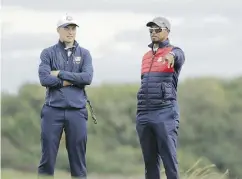  ?? CHARLIE RIEDEL / THE ASSOCIATED PRESS ?? U. S. vice- captain Tiger Woods confers with Jordan Spieth during a Ryder Cup practice round Tuesday in Minnesota.