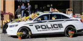  ?? JOHN SPINK PHOTOS / JSPINK@AJC.COM ?? A memorial to slain Gwinnett County police officer Antwan Toney was in front of the Gwinnett County Police Annex on Monday at 800 Hi Hope Road in Lawrencevi­lle. Toney was shot Saturday afternoon. Police believe Tafahree Maynard fired the shot that killed Toney.