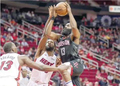  ?? — USA Today Sports ?? Houston Rockets’ James Harden (13) shoots the ball as Miami Heat’s Justise Winslow (20) defends during the first quarter at Toyota Center.