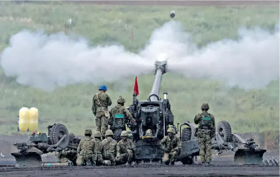  ?? Photo: Reuters ?? Japanese Ground Self-Defence Force fires a howitzer during an annual training.