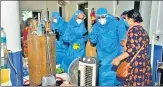  ?? AFP ?? CM Pramod Sawant (R), wearing a PPE suit speaks to Covid-19 patients at the GMCH in Panjim on May 11.