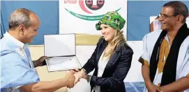  ?? Pictures: Michael Cost ?? JUST REWARD: The president of the Saharawi National Commission for Human Rights, Abba Salek Elhassa, left, honours South African internatio­nal climate activist and human rights defender, Catherine Constantin­ides. With them is Luali Musa.