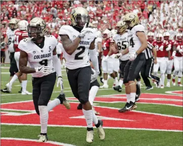  ?? NATI HARNIK — THE ASSOCIATED PRESS ?? Colorado’s Laviska Shenault Jr., right, gestures to the crowd after scoring in Saturday’s win at Nebraska.