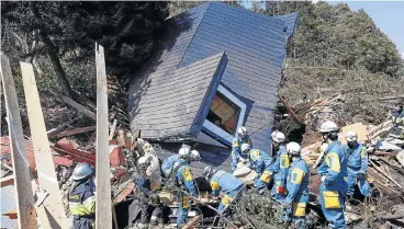  ?? /Kyodo/via Reuters ?? Frantic search: Rescue workers sift through debris looking for survivors from a house damaged by a landslide caused by an earthquake in Atsuma town, Hokkaido, in Japan in this photo taken by Kyodo on Thursday.