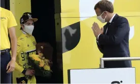  ?? Photograph: Christophe Petit-Tesson/EPA ?? France’s president, Emmanuel Macron, greets Primoz Roglic of the Jumbo-Visma team in the overall leader’s yellow jersey.