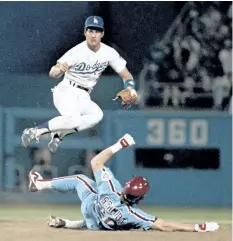  ?? AP FILES ?? Philadelph­ia’s Mike Schmidt tries to take out Los Angeles’s Steve Sax to break up a double-play in this Oct. 6, 1984, file photo. Sax won two World Series rings, was a five-time All-Star and got nearly 2,000 hits in the big leagues. Yet to many fans,...