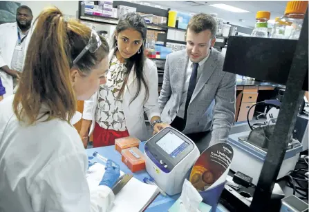  ??  ?? Noblegen CEO, co-founder Adam Noble and CCO, executive vice president and co-founder Andressa Lacerda chat with summer intern and research assistant Angela Sorensen after announcing the opening of its series B round of financing on Thursday at Trent University's DNA Building in Peterborou­gh.