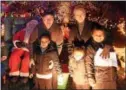  ??  ?? Juliana and Lailana Curtis with Isaiah Torres and Jerry and Jean Corrado at their Christmas light display on Nobb Hill Drive in East Bradford.