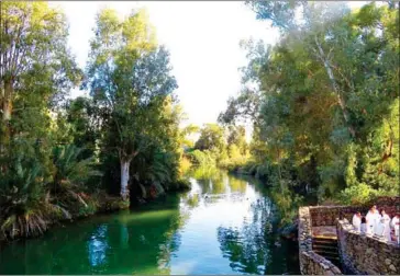  ??  ?? Hundreds of thousands of pilgrims dip into the Yardenit Baptismal Site along the Jordan River every year.