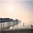  ??  ?? A dawn paddleboar­der at Southwold pier