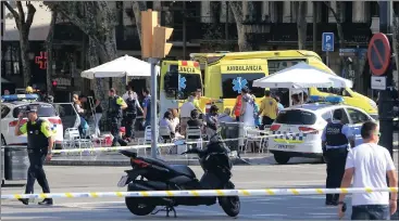  ?? Picture: AP ?? FIRST AID: Injured people are treated in Barcelona, Spain, yesterday after a white van jumped the sidewalk in the historic Las Ramblas district, crashing into a crowd of residents and tourists and injuring dozens of people, police said.