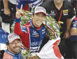  ?? AP PHOTO ?? Takuma Sato celebrates after winning the Indianapol­is 500 at Indianapol­is Motor Speedway.