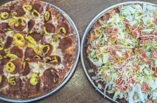  ??  ?? A pepperoni and banana pepper pizza, left, and a taco pizza at Eagles Pizza in New Albany.