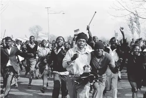  ??  ?? The Young Lions, 16 June 1976
The students wanted to stop Peter Magubane from taking photograph­s on the morning of 16 June 1976, but Magubane explained to them: “A struggle without documentat­ion is no struggle.” They agreed and issued an instructio­n that photograph­ers and journalist­s be allowed to document the march.
Photo: Peter Magubane