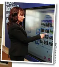  ?? D R A L I G E G R O E G s: e r u t c i P ?? The modern way: Holly Black and TSB Enfield branch manager Francesca Bell (above) use bank touch screens. Below: The old TSB and the high-tech branch