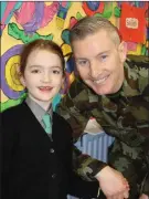  ??  ?? Lauren Ní Chonchúir with her father Thomas, a member of the Army Band 1 Brigade, who played at the official opening of the new extension at Gaelscoil Thomais Dáibhís.