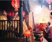  ??  ?? An Indonesian man holds burning incense at a temple in Jakarta.