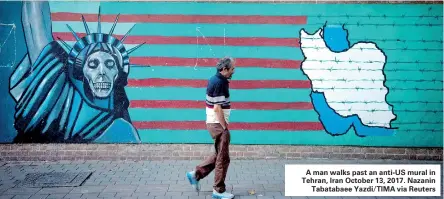  ??  ?? A man walks past an anti-US mural in Tehran, Iran October 13, 2017. Nazanin Tabatabaee Yazdi/TIMA via Reuters