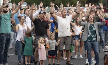  ?? Photograph: Geoff Crimmins/AP ?? Christ Church members and guests sing in protest of a city public-health order intentiona­lly not wearing masks outside City Hall in Moscow, Idaho, last year.