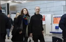  ?? LEWIS JOLY — THE ASSOCIATED PRESS ?? Palestinia­n French lawyer and activist Salah Hammouri walks with his wife Elsa Lefort as he arrives at the Charles de Gaulle Airport after his extraditio­n from Israel to France on Sunday in Paris.