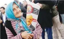  ?? — Reuters ?? A woman holding a picture of Jamal Khashoggi attends a symbolic funeral prayer for Khashoggi at the courtyard of Fatih Mosque in Istanbul.