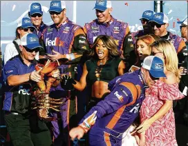  ?? JEFF ZELEVANSKY / GETTY IMAGES ?? Denny Hamlin moves away from crew chief Mike Wheeler and the lobster traditiona­lly given to the winner at New Hampshire Motor Speedway.