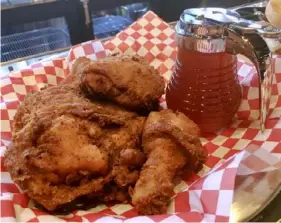  ?? Dan Gigler/Post-Gazette ?? A platter of fried chicken served with hot honey at The Eagle, Downtown.