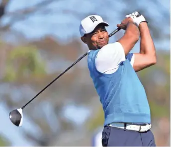  ?? ORLANDO RAMIREZ, USA TODAY SPORTS ?? Tiger Woods tees off Jan. 26 in the first round of the Farmers Insurance Open, where he missed the cut. He hasn’t played competitiv­ely since and had back surgery in April.