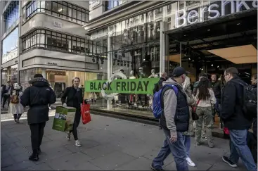  ?? MARY TURNER — THE NEW YORK TIMES ?? Friday deals abound in the Oxford Circus district of London. U.S.-style Black Friday sales have become common in Europe, as the holiday shopping season shifts earlier, but with less disposable income, buyers may be more wary this year.