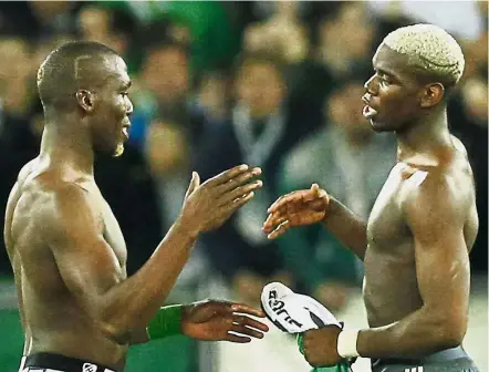  ?? — Reuters ?? Respect: Manchester United’s Paul Pogba (right) and his brother Florentin of St Etienne swap shirts after the match.